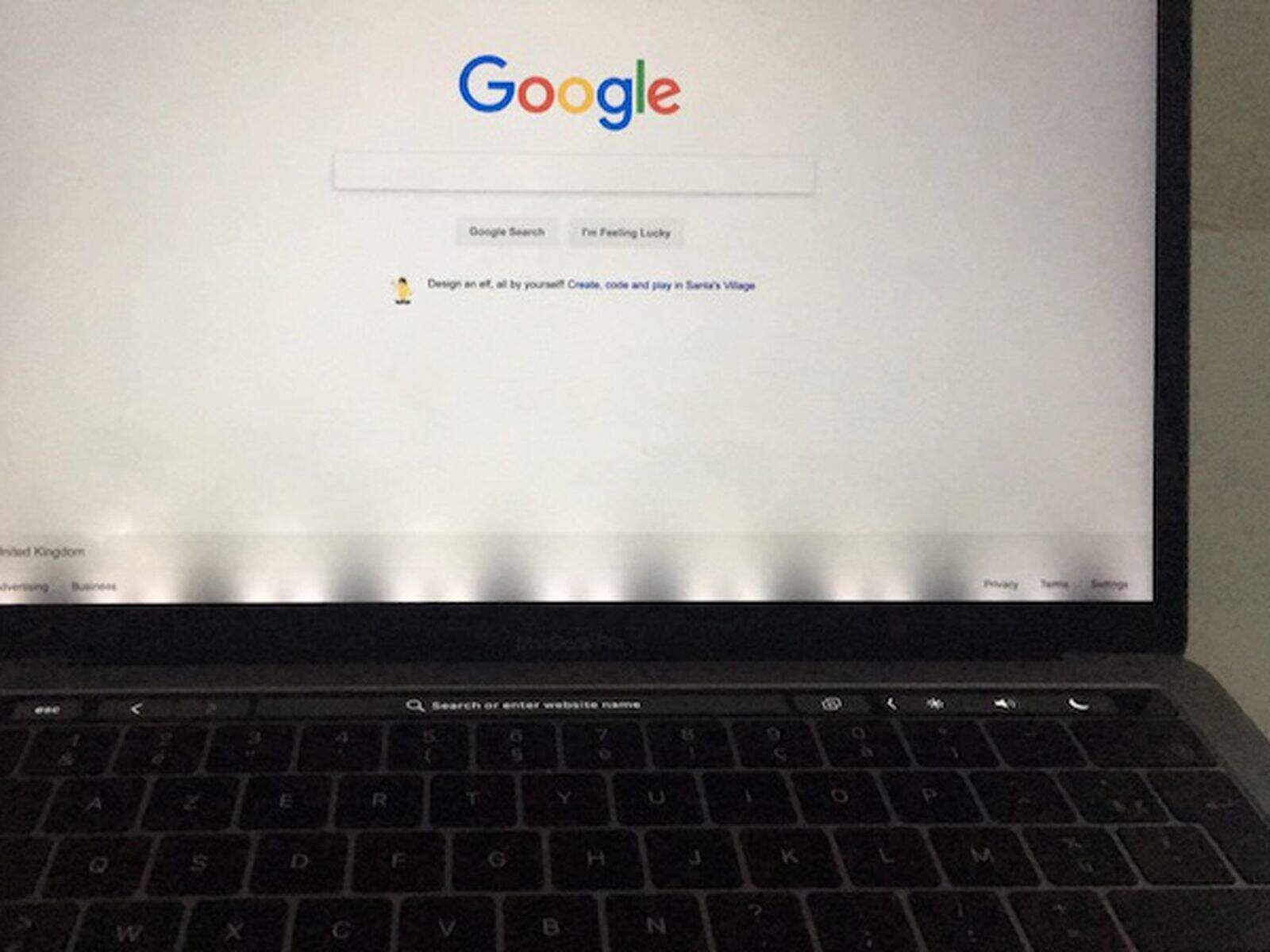 MacBook Pro screen showing stage light effect at the bottom bezel
